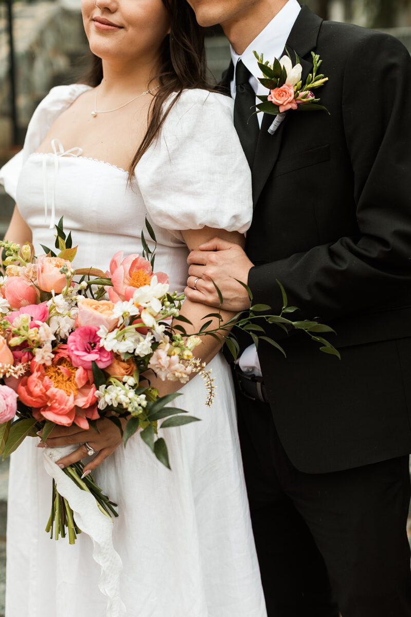 bride and groom posing on steps in the heart of old town fairfax