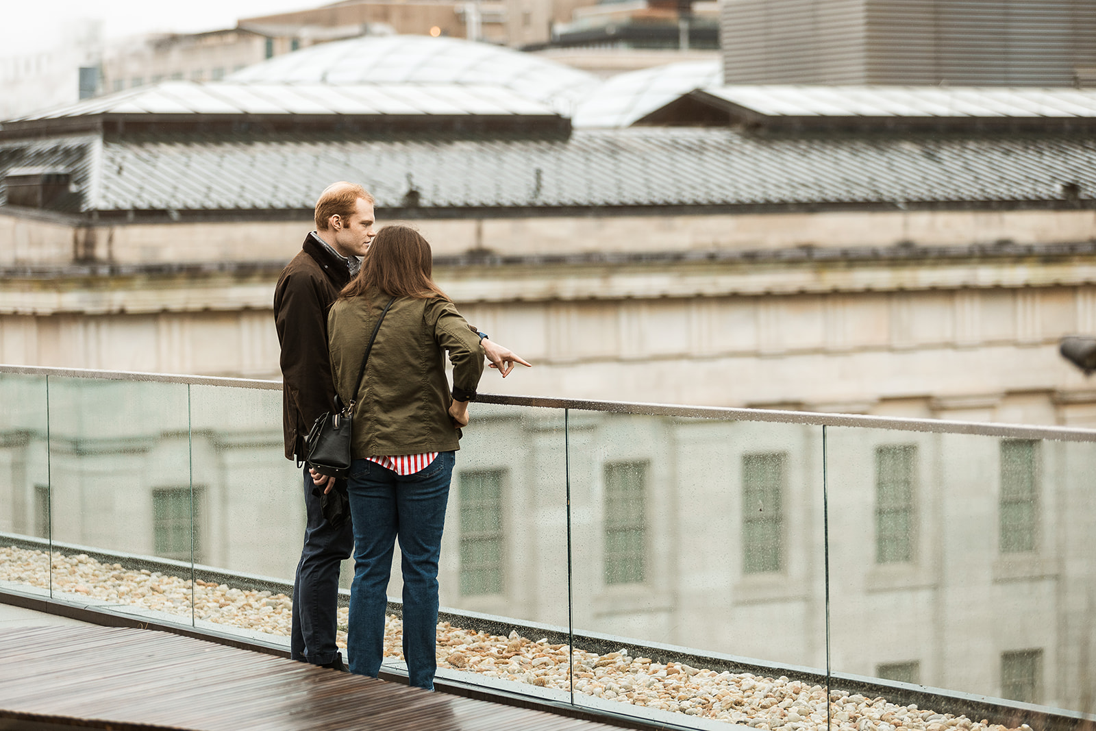 couple gazing at the city views from rooftop