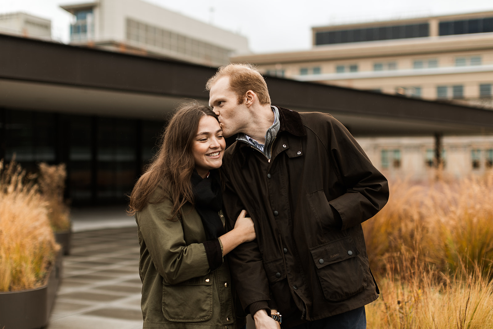sweet couple snuggling on a rainy rooftop in dc
