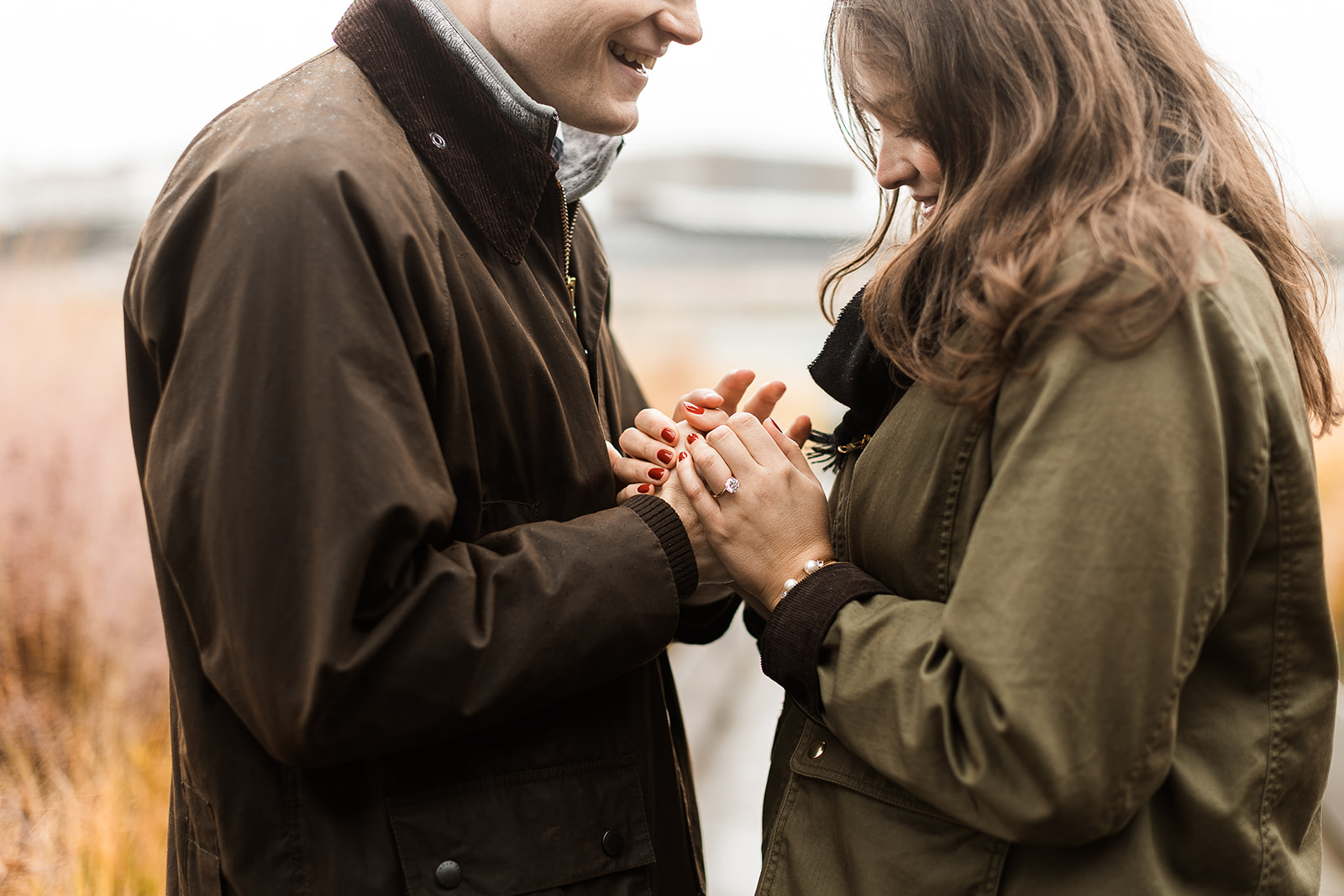 sweet couple snuggling on a rainy rooftop in dc